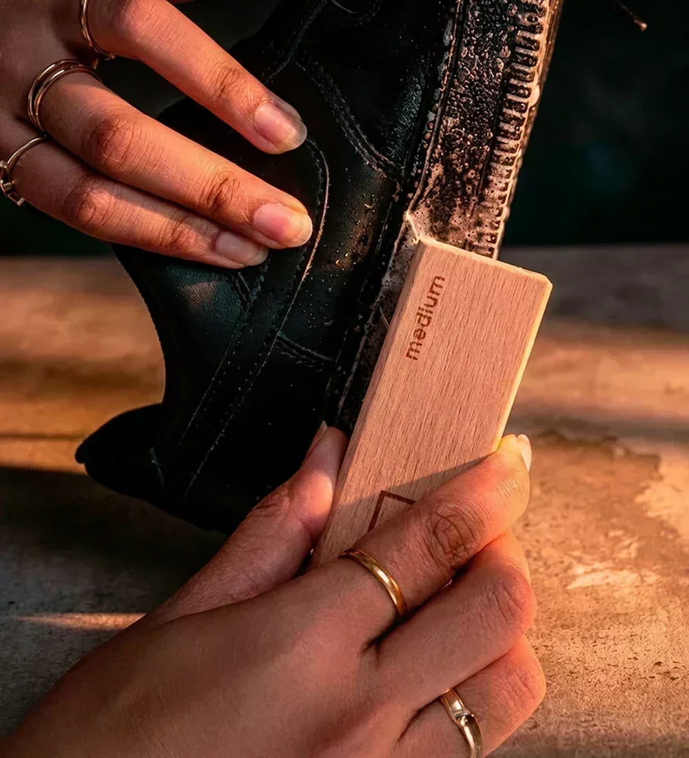 A man cleaning sneaker midsoles using SHOEGR Medium Brush