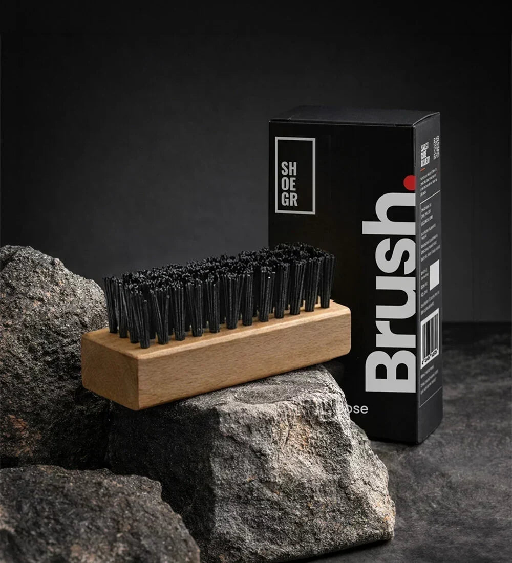 SHOEGR All-purpose Brush with Short Black Bristles for Cleaning Sneakers and Shoes on a Black Background with its packaging.